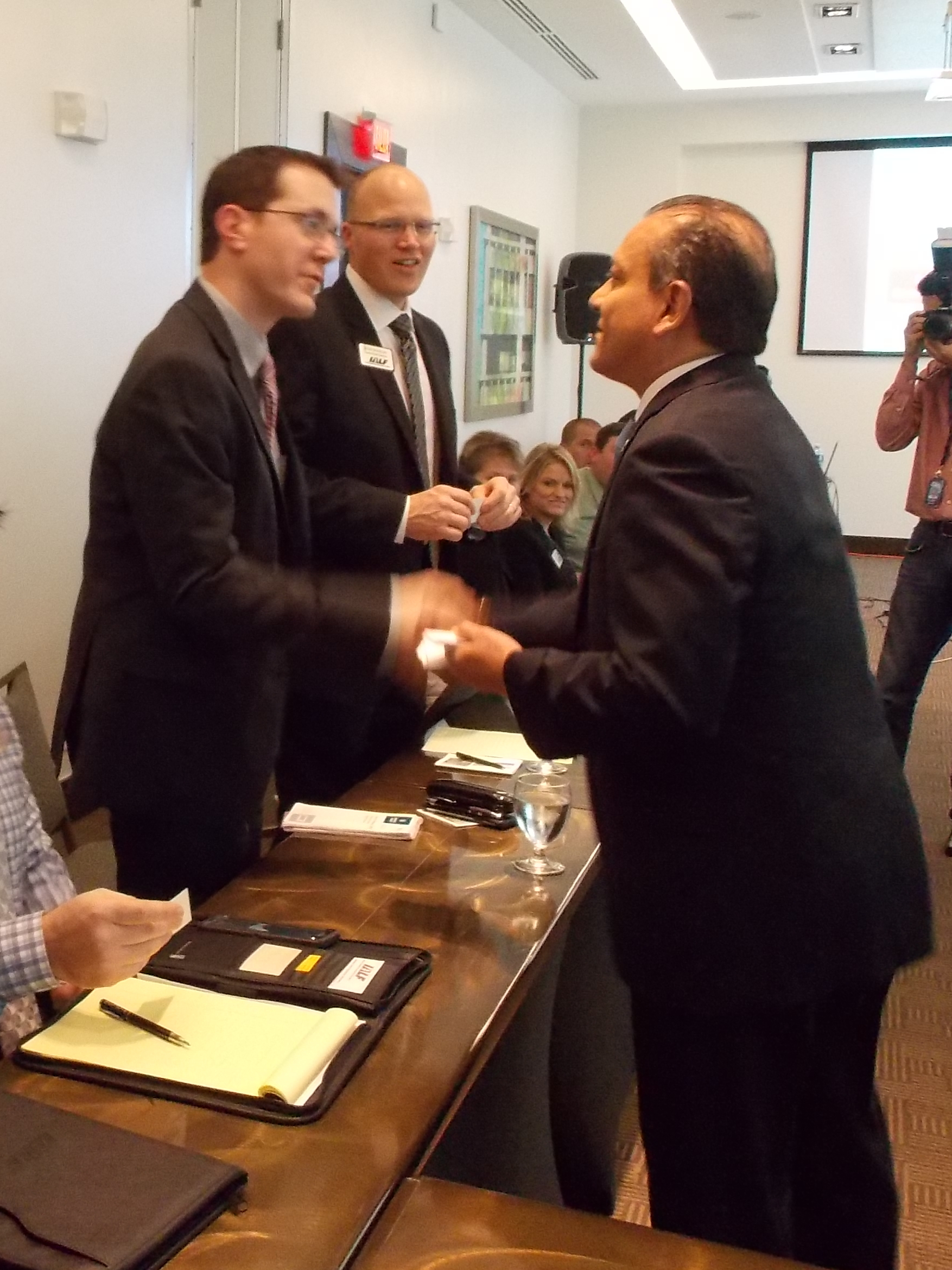 Class members Steve Bridge and Ryan Buckles greet and trade business cards with Panama Vice Minister of Interior Commerce & Industry, Manuel Grimaldo.